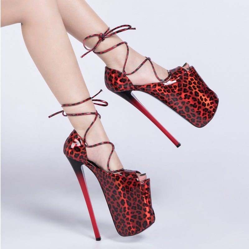 Extremely high platform stiletto heels with red leopard print and ankle laces.