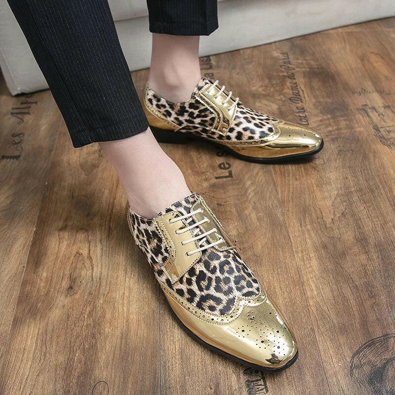 Pair of leopard print and gold wingtip oxford shoes.