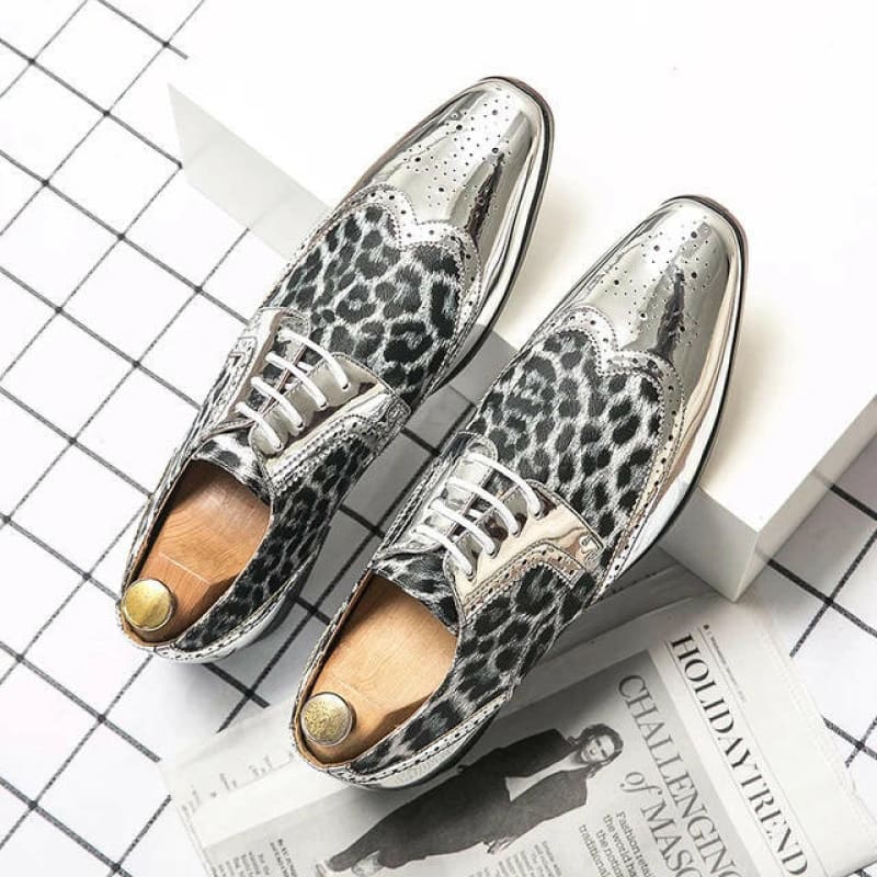 Pair of silver and leopard-print leather dress shoes with pointed toes.