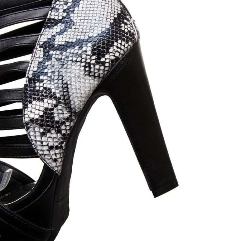 High-heeled shoe with a snakeskin pattern and black accents.