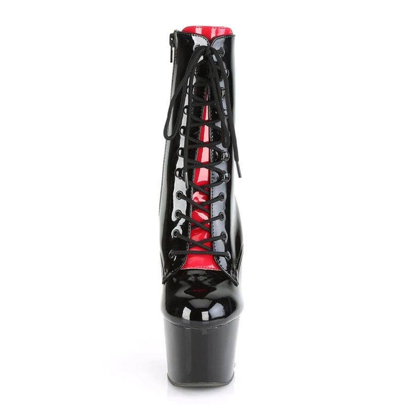 Black patent leather platform ankle boot with red interior and lace-up front.