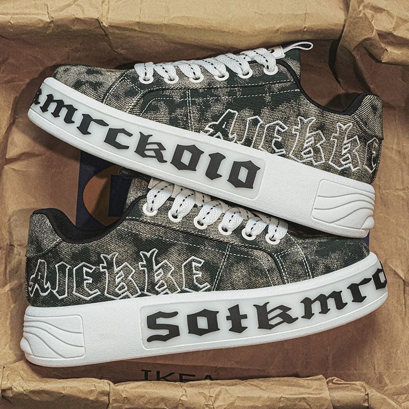 Pair of black and white sneakers with custom graffiti-style lettering on the sides.