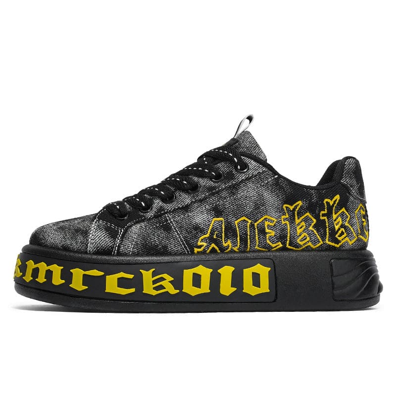 Black sneaker with yellow Gothic-style lettering on the side and sole.