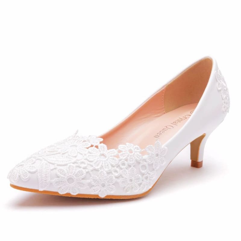White lace kitten heel pump with a pointed toe and delicate floral embellishments.