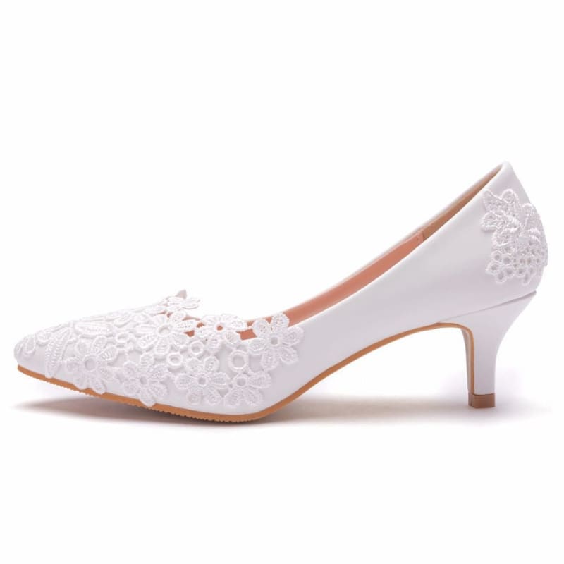 White lace kitten heel pump with a pointed toe.