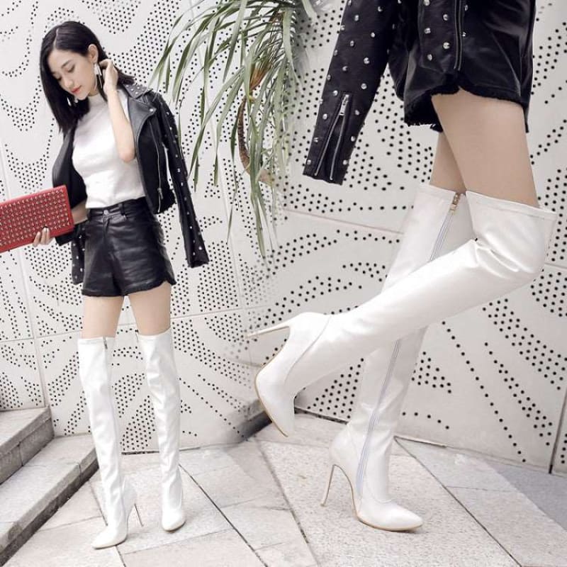 White knee-high boots with very high stiletto heels.