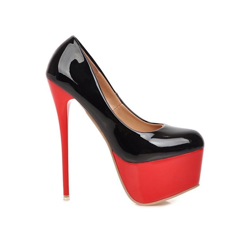 High-heeled platform pump with a black patent leather upper and red stiletto heel and platform.