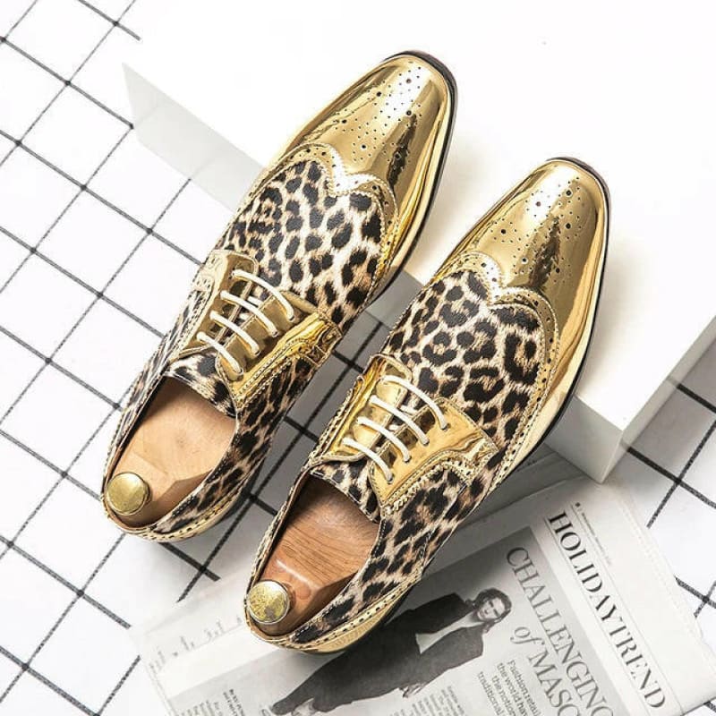 Pair of gold and leopard print dress shoes with pointed toes.